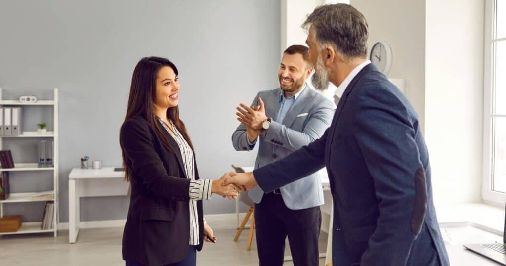 Employee being recognized by senior leadership during a professional introduction in the workplace