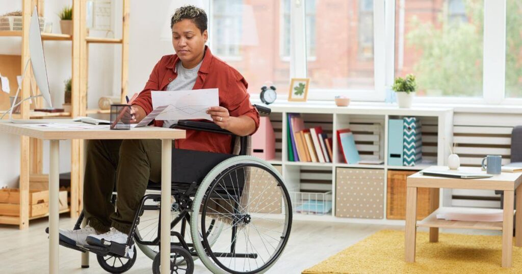 female professional in wheelchair at desk working